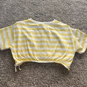 White and yellow striped cropped shirt with a small cinch at the bottom